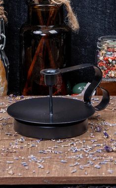 an old - fashioned cast iron skillet sits on a table next to other items