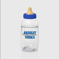 an empty glass bottle with a blue top and plastic cap on the bottom that says absolut vodka