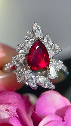 Bienvenue chez Odyssée Joaillerie, nous nous spécialisons dans le diamant coloré,  et les bagues de fiançailles. Nous offrons un grand choix: blanc, ou jaune, ou rose, platine,  nos bijoux sont finement fabriqués pour une qualité exceptionnelle! Symbole d'amour par excellence, le diamant est une belle preuve d'amour. Le joyau de vos rêves est le vôtre! Détails : Marque: Odyssée Joaillerie Métal : or blanc et jaune 18k  * Pierre centrale : Rubis 2,03ct AIGS * Pierres latérales: Diamants incolore Diamond Ruby Ring With Prong Setting In Pear Shape, Pear-shaped Ruby Ring With Diamond, Pear-shaped Ruby Ring With Diamond Halo, Pear-shaped Ruby Ring With Diamond Halo Setting, Pear-shaped Ruby Ring With Halo Setting, Proof Of Love, Colorless Diamond, Ruby Ring, Love Symbols