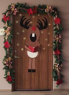 the door is decorated with christmas decorations and reindeers holding a red book in his hands