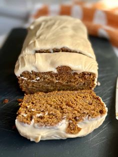 a loaf of carrot cake sitting on top of a cutting board