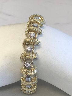 "18kt Yellow Gold Heavy Solid Lady's Cubic Zirconia (CZ) Bracelet 7\" in Length. This Bracelet consists of 18- 3mm, .10ct each , 1.80ctw Cubic Zirconia (CZ) all prong set in 14kt White Gold settings in a heavy solid 12mm wide hinged mounting. There is a hidden box clasp with a secure fig 8 safety clasp. These CZ's look so real. Total mounting weigh is 43.8 grams. This item would Retail for $6,550.00" Exquisite Yellow Gold Bracelet With Diamonds, Fine Jewelry Gold Bracelet With Diamond Cut Cubic Zirconia, Gold Cubic Zirconia Bracelet With Diamond Accents For Anniversary, Dazzling Yellow Gold Diamond Bracelet For Anniversary, Anniversary Dazzling Yellow Gold Diamond Bracelet, Gold Cubic Zirconia Tennis Bracelet Hand Set, Gold Diamond Cut Bracelet With Dazzling Style, Gold Diamond Cut Dazzling Bracelet, Exquisite Gold Tennis Bracelet For Anniversary