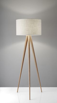 a wooden tripod floor lamp with a white shade