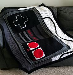 a black and white bag with a red cross on the front is sitting on the floor