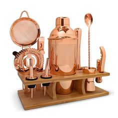 a set of copper bar accessories on a wooden tray