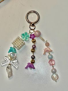 a close up of a key chain with charms on it's end and an animal