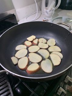 potatoes being cooked in a frying pan on top of an electric stove burner