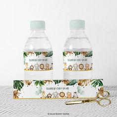 two clear water bottles sitting next to each other on top of a white tablecloth