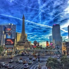 the eiffel tower towering over the city of las vegas, nv at dusk