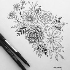 an image of flowers drawn on paper with two markers and pencils next to it