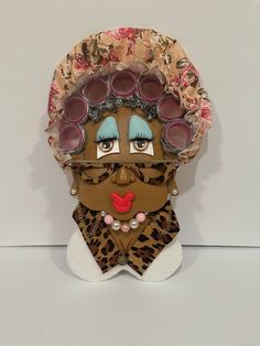 a sculpture with sunglasses on top of it's head and a leopard print scarf around its neck