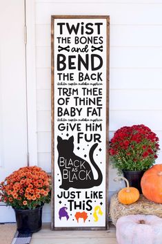 a sign that says twist the bones and bend the back with black cat on it