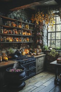 an old fashioned kitchen with lots of pots and pans on the stove top, surrounded by greenery