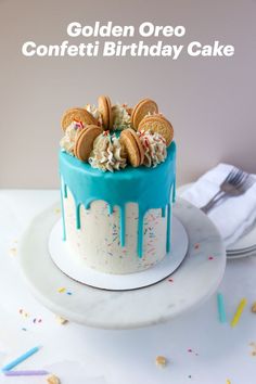 a birthday cake with cookies and sprinkles on it, sitting on a plate