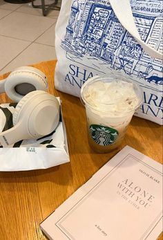 starbucks coffee and headphones on a table