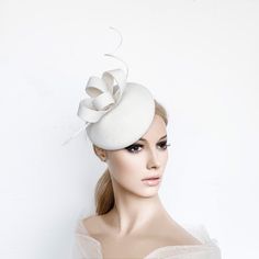 Ivory cocktail hat hand blocked on a button shape wood hat block, made with wool felt and trimmed whith a ostrich spine and a felt bow in Kate Middleton Style. This hat is perfect for winter races, christmas parties, weddings or any special occasion. It is mounted on a elastic . ** MADE TO ORDER (2-5 DAYS) ** DELIVERY TIME (DHL EXPRESS WITH TRACKING NUMBER): 2-4 business days to EEUU, 1-2 to Europe and 3-5 to Australia. Follow this link for more beautiful choices from 'Sophie Young Hats' https:/ White Fascinator For Kentucky Derby Gift, White Mini Hats For Royal Ascot, Elegant White Hat For Gift, Elegant Fascinator With Pinched Crown For Gift, Elegant Pinched Crown Fascinator Gift, Elegant Adjustable Felt Top Hat, Elegant Cream Headpiece For Gift, White Curved Brim Felt Hat For Parties, White Felt Hat With Curved Brim For Party