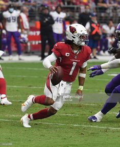 a football player running with the ball in his hand and another team behind him on the field