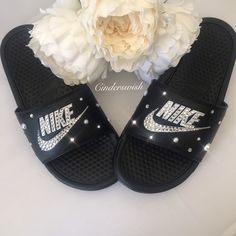 For the most original and classy Nike sliders we have added beautiful Pearl touches along with maximum sparkle Swarovski crystals to these Nike Sliders.  - Swarovski crystals hand placed to ensure maximum sparkle. - Both the logo and Swoosh are sparkled as shown.  - Pearls and crystals scattered for a truly original and classy look!   We can do this design on the Rose Pink, White or Black Nike sliders! Nike Sliders, Nike Benassi Slides, Swarovski Nike, Nike Flip Flops, Cute Slides, Pink Nike Shoes, Nike Benassi, Nike Slides, Cute Nike Shoes