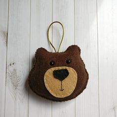 a brown bear ornament hanging on a white wall