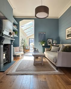 a living room filled with furniture and a fire place next to a fireplace in a home