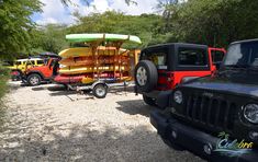 several jeeps are lined up with kayaks on them