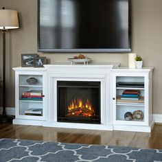 an entertainment center with a fireplace in the middle and a flat screen tv above it