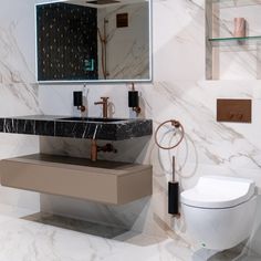 a bathroom with a toilet, sink and mirror on the wall next to each other