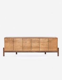 the sideboard is made out of wood and has brass hardware