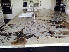 a large kitchen counter top with brown and white marble