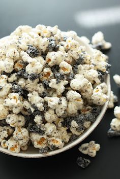 a white bowl filled with popcorn on top of a table