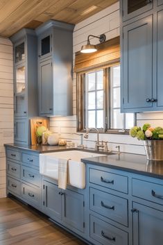 a kitchen with blue cabinets and white walls