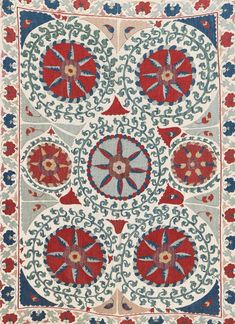 an intricately designed rug with red, blue and white designs on the bottom half