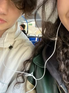 two girls with ear buds on their ears