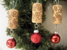 three cork ornaments hanging from a christmas tree