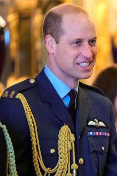 the duke of cambridge smiles as he wears his uniform