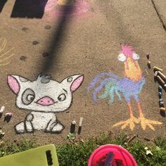 a child's drawing on the ground with chalk and crayons