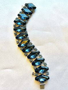 "Beautiful kite shaped blue glass stones on an articulated bracelet band. Smaller light blue crystals on either side, all prong set. This bracelet is in near perfect condition. I have added the safety chain. The closure is a slide in and lock. 7 1/4\" in length by 7/8\" wide." Light Blue Crystals, Crystal Cuff Bracelet, Simple Bracelets, Mala Bracelet, Safety Chain, Yoga Jewelry, Glass Beaded Bracelets, Blue Jewelry, Wire Bracelet