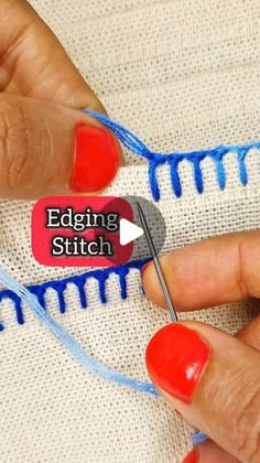 a woman is stitching the edge of a piece of fabric with a sewing needle