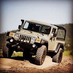 a white jeep driving down a dirt road