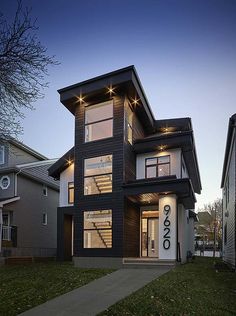 a modern house with black siding and windows