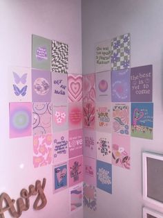 a room with pink walls and lots of different pictures on the wall, including hearts