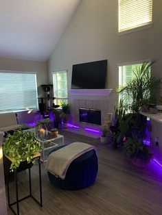 a living room filled with furniture and a flat screen tv mounted on the wall over a fireplace