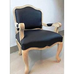 a black and white chair sitting on top of a tile floor next to a wall