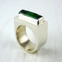 - Size: 58.5 (FR) ; 8.1/2 (US) Feel free to contact us in case there is an issue with the size! -Fabrication & materials- Entirely fabricated by hand in our studio of Aix-en-Provence this ring is made of sterling silver. It is set with a crystal of raw green tourmaline. The setting has been carefully adjusted to perfectly fit the stone, enhancing its natural silhouette. Like all of our jewelry, this ring has been made individually with traditional tools without casting or molding. It has some small irregularities which contribute to making it unique! - Care instructions- Like every noble metal, silver is very resistant to corrosion: time gives it a beautiful patina which contributes to its charm. A superficial layer of oxidation can however appear. It will be easily removed with a cleaning Raw Tourmaline, Green Tourmaline Ring, Lapis Ring, Jewelry Men, Signet Rings, Tourmaline Ring, Green Tourmaline, Signet Ring, Jewellery Making