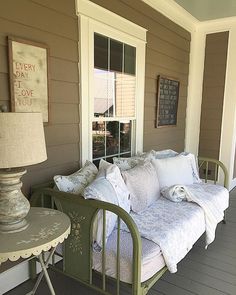 a couch sitting on top of a wooden porch