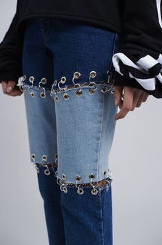 someone is holding their jeans with chains on them