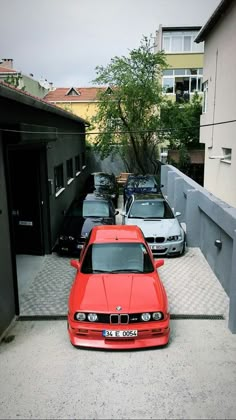 a red car parked in front of a garage