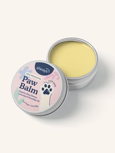 an open tin of paw balm on a white background