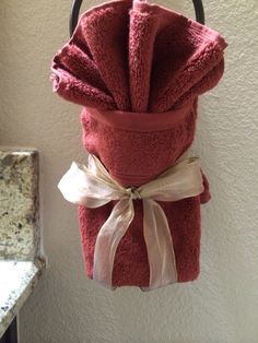 a red towel hanging from a hook in a bathroom