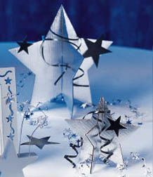 three paper stars on top of snow covered ground with blue background and white envelopes